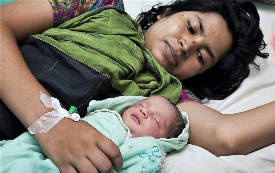 A mother caressing a newborn baby.     Photo: Social Media 