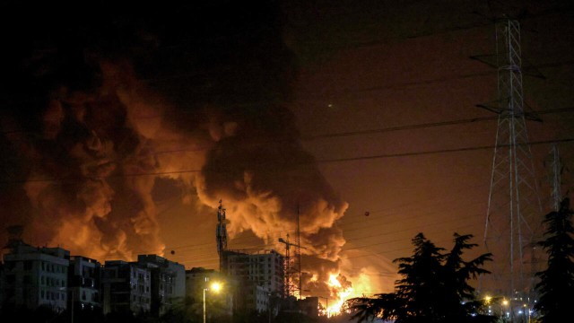 This image captures the devastating impact of Israeli airstrikes on Tehran's oil refinery, leading to significant infrastructure damage. ATTA KENARE/AFP via Getty Images