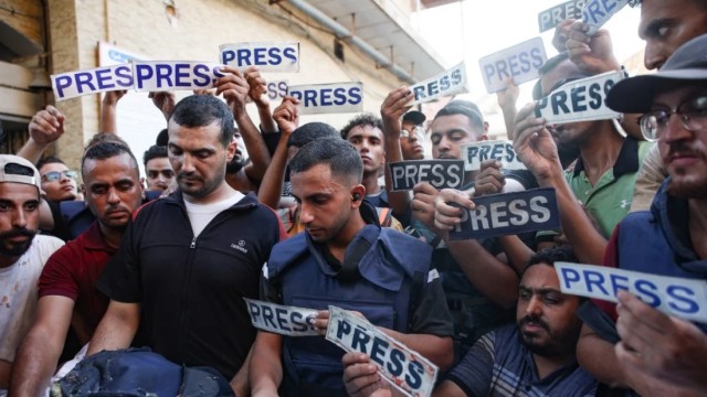 File image: Mourners and colleagues hold `press` signs for an Al-Jazeera Arabic journalist, killed along with his cameraman in an Israeli strike, on July 31, 2024. Photo: AFP