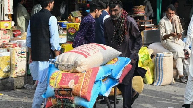 A labourer transports food bags at a market in Muzaffarabad on May 2, 2025. Photo: AFP