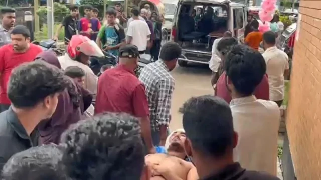"Masum Billah, critically injured in a hammer attack, is transported to the hospital by local residents."