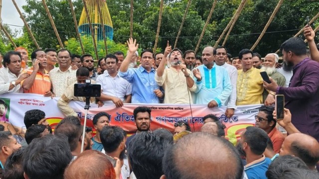 BNP leader Khokon Talukder addresses a rally in Madaripur, marking the anniversary of the mass uprising, vowing to resist corruption and defend democratic progress.