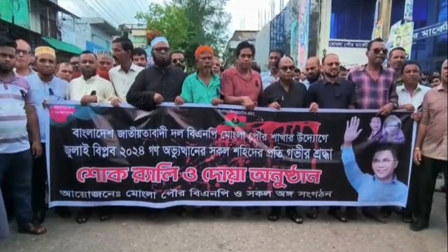 BNP leaders and supporters participate in a mourning rally in Mongla on Friday, commemorating the July martyrs; the procession marched through key city streets before concluding with a gathering at the Municipal Market premises.