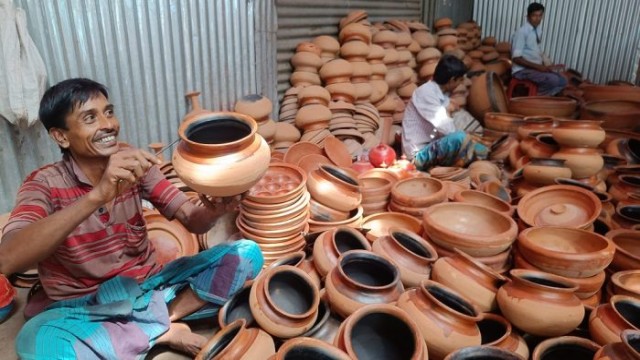 A local potter in Bagmara smiles while shaping clay, keeping the centuries-old craft alive through dedication and hard work.