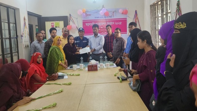Graduates of BRAC’s Shopnosarthi program in Kathalia, Jhalokathi, receive certificates and awards during the graduation ceremony, attended by local officials and BRAC representatives.