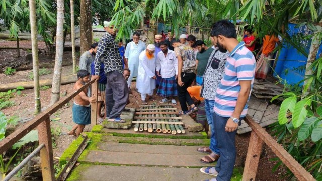 Residents of South Aura in Kathalia Upazila reinforce a decades-old iron bridge with bamboo on August 9, after years of official inaction left it dangerously unstable.