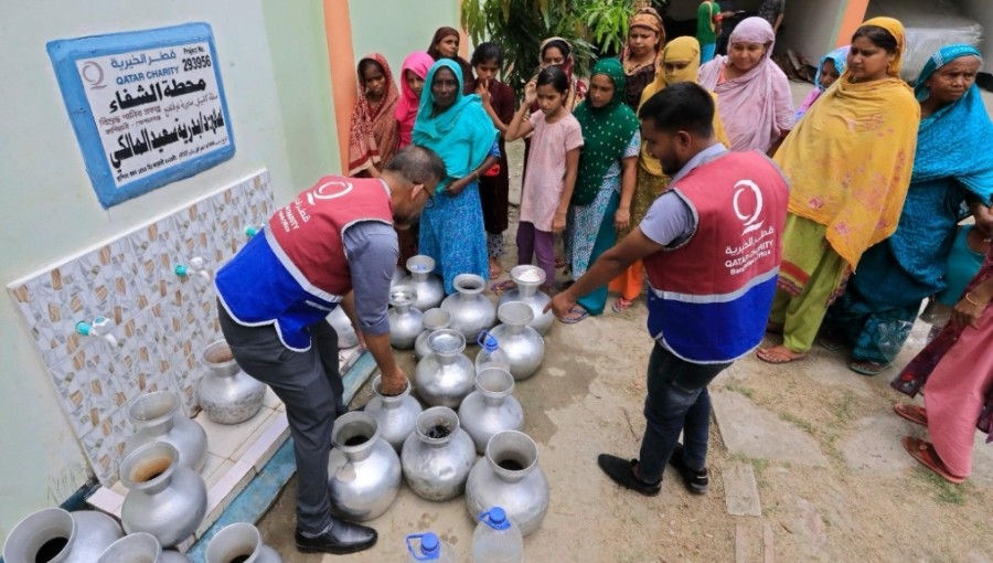 Qatar Charity volunteers distribute clean water to a community in need, ensuring access to this vital resource.