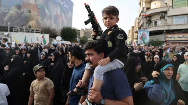 "Protesters in Tehran chant anti-U.S. and anti-Israel slogans following airstrikes on Iranian nuclear facilities."