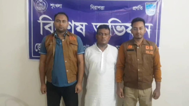 Billal Hossain, a Swechchhasebak League leader, is escorted by police after being arrested in Ashulia for drug trafficking and other criminal activities.