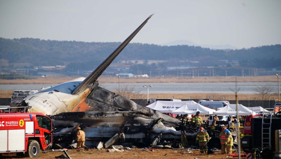 Firefighters work the scene of the crashed aircraft at Muan International Airport in Muan, South Korea, on December 29.