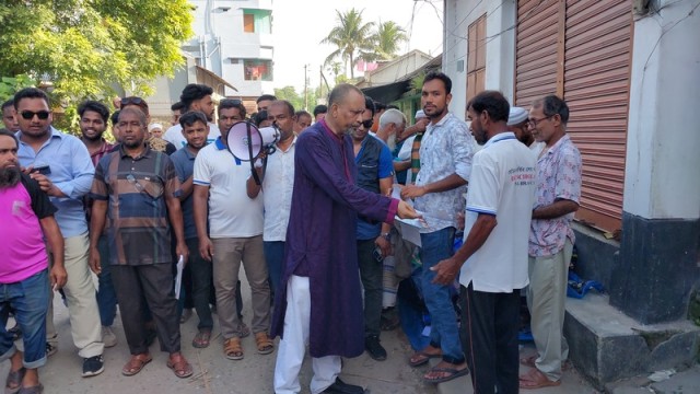BNP nomination hopeful Hasanul Islam Raja distributes leaflets outlining Tarique Rahman's 31-point agenda during a public outreach campaign in Pabna-3.