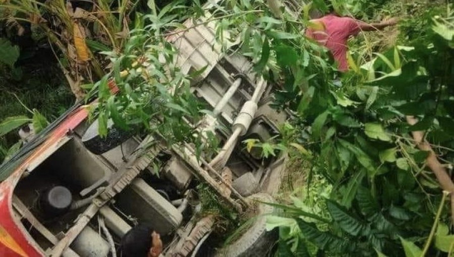 A passenger bus lies in a ditch after an accident in Chonagacha Bazar, Sirajganj, on September 14. Nearly 40 people were injured as the bus swerved to avoid a reckless CNG vehicle. Photo: V7N