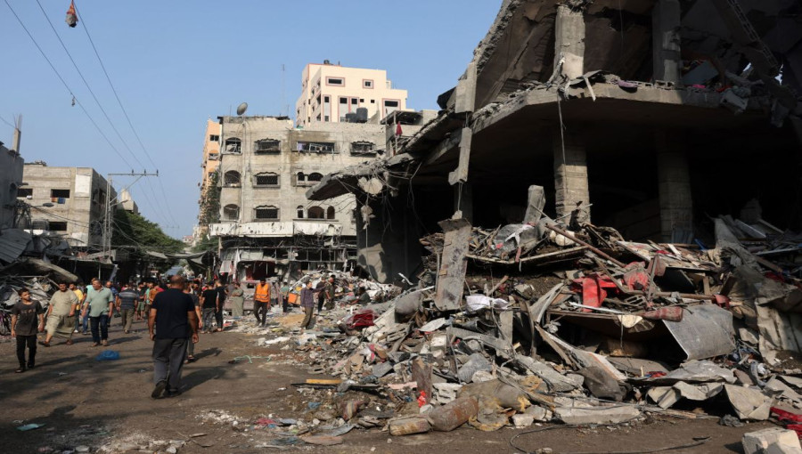 Rescue workers search through the rubble of a school sheltering displaced civilians in Gaza, following an Israeli airstrike that killed at least 28 people. The attack has worsened the humanitarian crisis in the region, with many others injured and trapped under the debris.