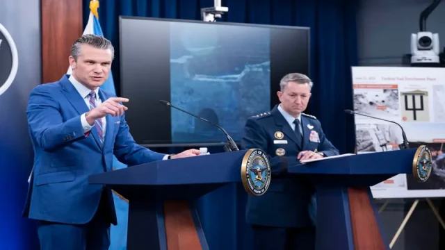 U.S. Secretary of Defense Pete Hegseth and Chairman of the Joint Chiefs of Staff General Dan Kane speak during a press briefing at the Pentagon.