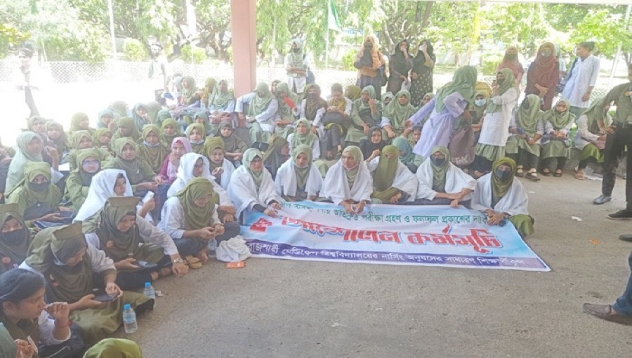 "Nursing students protest in shrouds in front of the Rajshahi Divisional Commissioner’s office; three have been hospitalized due to heatstroke." Photo: V7N