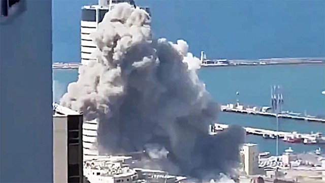 Smoke rises above Haifa’s industrial zone after an Iranian ballistic missile struck the northern Israeli port city on Friday night, injuring at least two people.