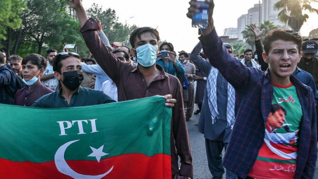 Activists wearing party flags and colors march through city streets in solidarity.