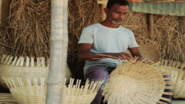 Artisans weaving traditional bamboo and cane products in a rural village, highlighting the fading craft that once formed the backbone of Bengali culture and rural livelihoods.