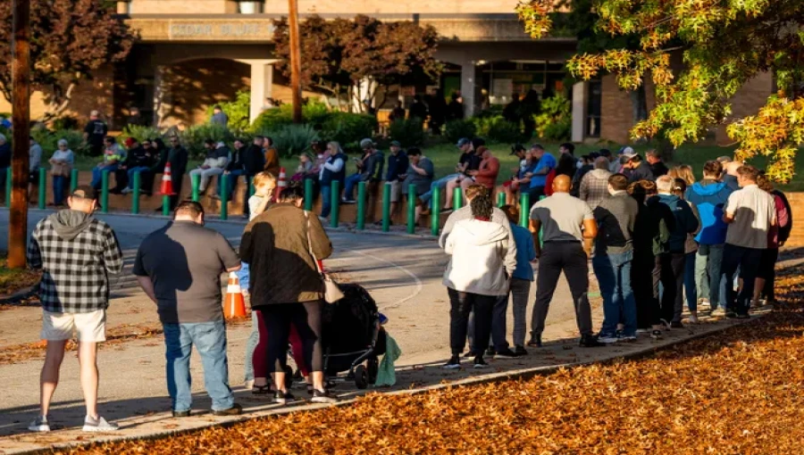 Voters wait in line to cast their ballots on Election Day 2024, as millions across the country participate in the historic race.