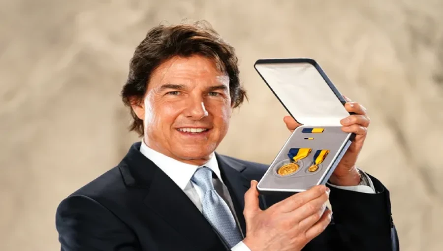 Tom Cruise receives the U.S. Navy's Distinguished Public Service Award for his dedication to raising awareness and appreciation for Navy personnel through his films.