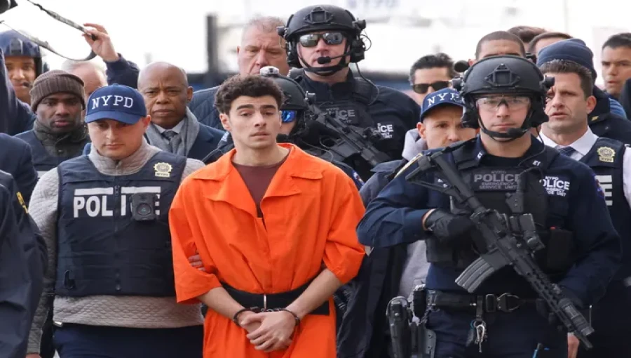 "Luigi Mangione, the suspect in the murder of UnitedHealth Group executive Brian Thompson, arrives at a helicopter pad in New York City after being extradited from Pennsylvania, with Mayor Eric Adams walking behind him, Dec. 19, 2024."