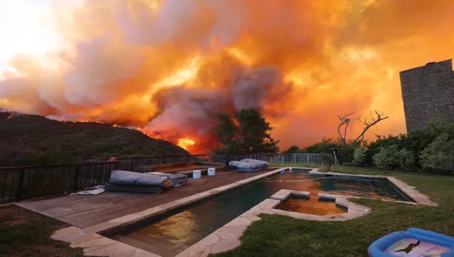 "An aircraft drops fire retardant over a wildfire burning near Pacific Palisades, Los Angeles, on January 7, 2025, as fierce winds intensify the blaze."