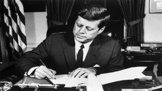 President John F. Kennedy signs the order for a naval blockade of Cuba on October 23, 1962, during the Cuban Missile Crisis. Photo: AFP via Getty Images