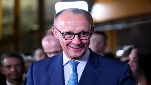 Friedrich Merz, leader of Germany's conservative party, celebrates with supporters after securing a mandate to form a coalition government following the national elections, as the country faces economic and diplomatic challenges.