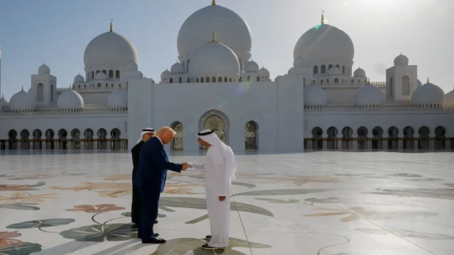 Donald Trump shakes hands with Sheikh Zayed Grand Mosque Director Yousif Al Obaidli, as Crown Prince Sheikh Khaled bin Mohamed Al Nahyan stands nearby in Abu Dhabi, UAE, May 15, 2025.