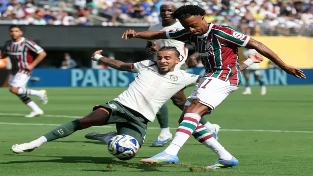 Fluminense's Keno (11) attempts to strike the ball past Chelsea's Malo Gusto during their intense semifinal match at MetLife Stadium in East Rutherford, New Jersey, as part of the 2025 FIFA Club World Cup.
