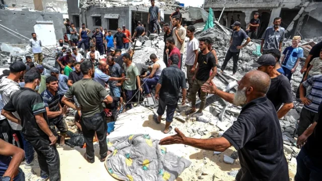 Rescue workers search for survivors through the wreckage of bombed buildings in Gaza, as airstrikes leave entire neighborhoods in ruins.