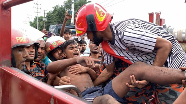 "Firefighters use hydraulic cutters to rescue a critically injured helper trapped inside a mangled mini truck after a brake failure led to a severe crash on the Rajshahi-Naogaon highway near Bayer Mor on July 2, 2025." (Photo: V7N)