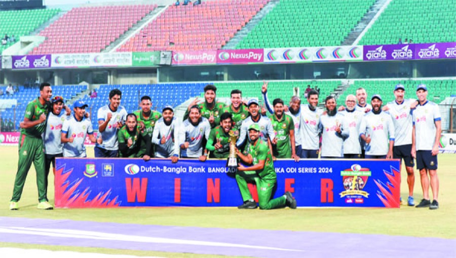 Bangladesh players and coaching staff members celebrate with the One Day International series trophy after beating Sri Lanka in Monday’s third match in Chittagong.