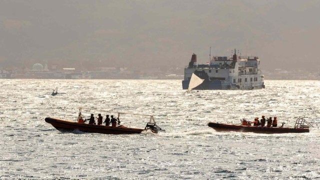 Indonesian rescue workers assist a survivor following the ferry accident between East Java and Bali on July 4, 2025. The disaster left at least four dead and 30 missing as search efforts continue across the Bali Strait. (Photo: people.com)