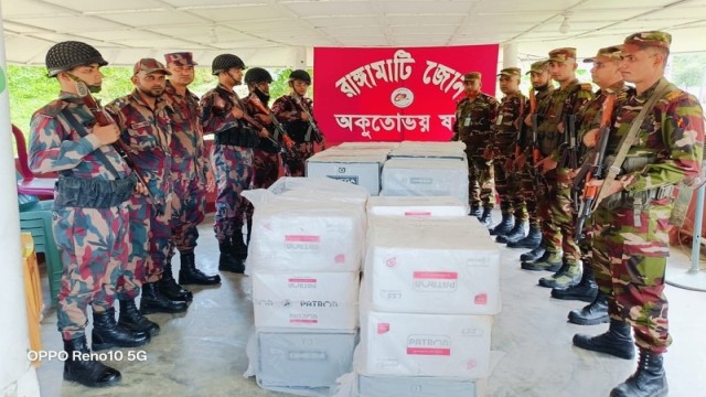 Security personnel inspect a seized consignment of foreign-brand cigarettes worth approximately Tk 2.5 million, recovered during a joint operation by the Army and BGB near Kaindar Mukh, Kaptai Lake, in Rangamati on June 28, 2025.