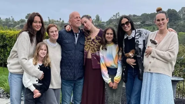 Bruce Willis poses with wife Emma Heming Willis, ex-wife Demi Moore, and their daughters in a rare family photo, published by Vanity Fair amid his ongoing battle with dementia.