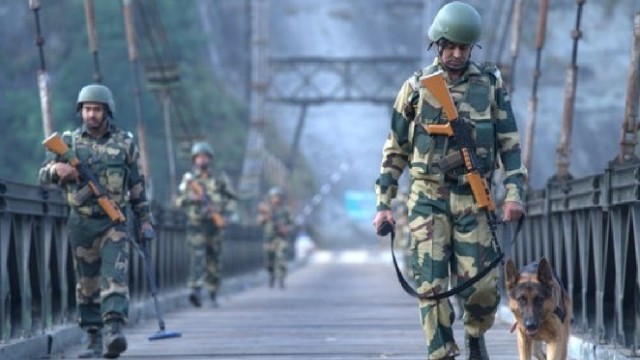 "Indian Border Security Force (BSF) soldiers stand guard at a forward post along the Pakistan frontier."