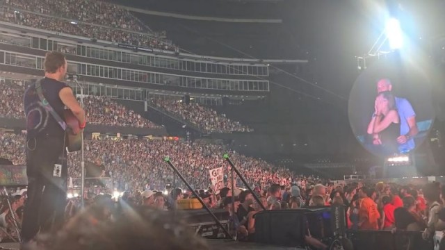 Coldplay frontman Chris Martin reacts on stage during the band’s Boston concert on July 16, after an awkward moment with a couple caught on the 'Kiss Cam' draws unexpected attention.