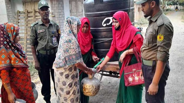 Ansar member Sagar Ali delivers water using his personal van in drought-affected Arani Municipality, Rajshahi Bagha upazila. He has been supplying thousands of liters daily to families in need. (Photo: V7N)