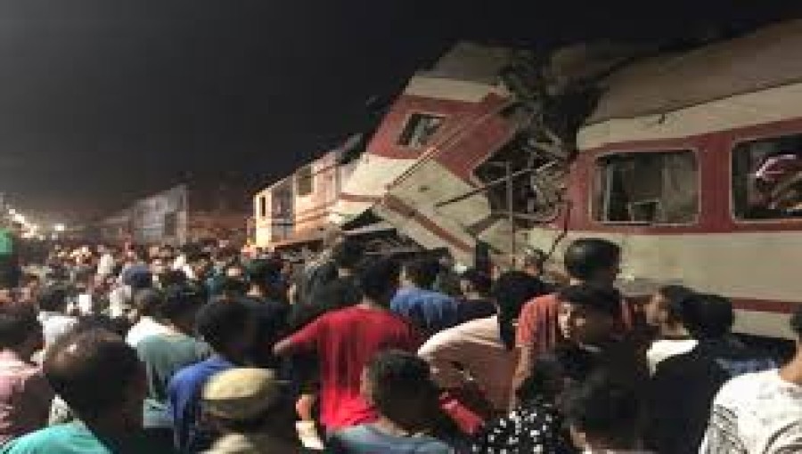 Crowds of people gather around two passenger trains that collided in the city of Zagazig, the capital of Egypt's Sharqiya province, on Saturday, Sept. 14, 2024.