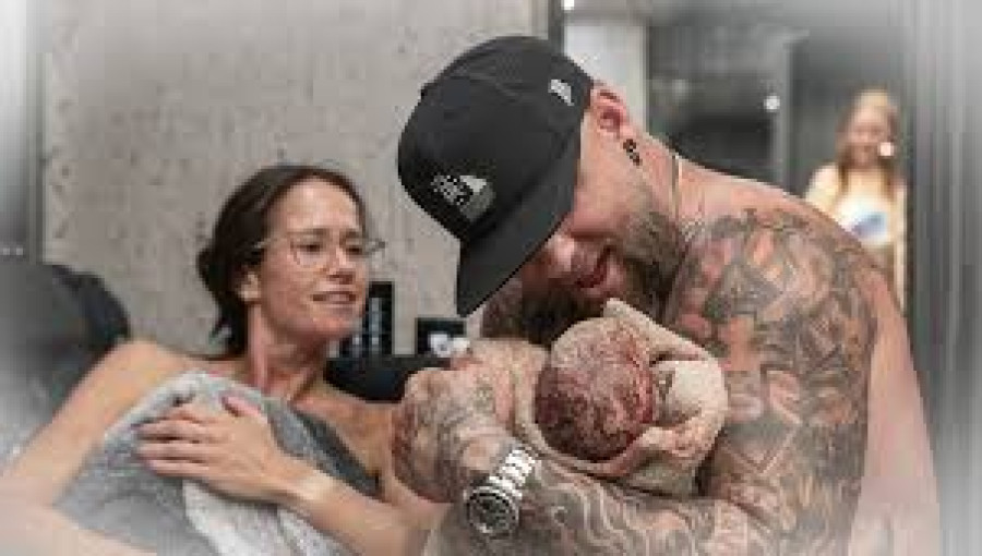 Brantley Gilbert celebrates the birth of his son, Abram, after pausing his concert mid-show when his wife, Amber, went into labor on their tour bus.