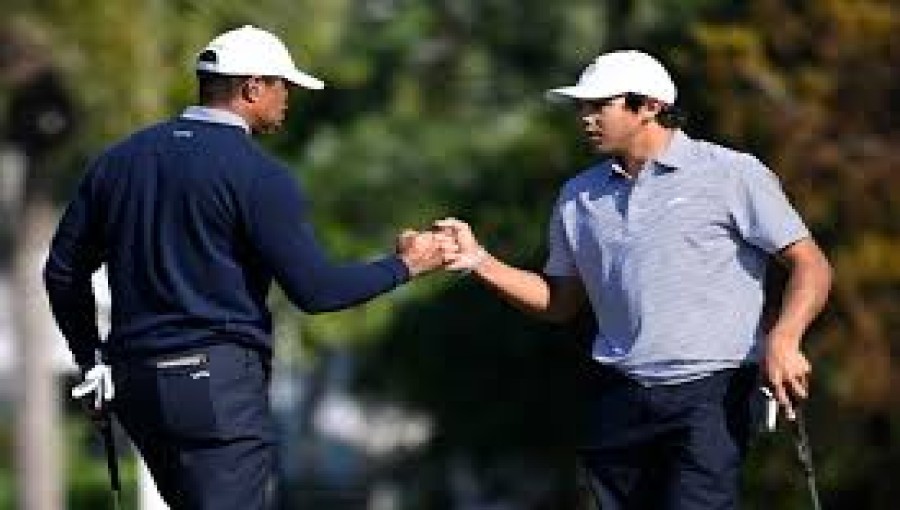 Tiger Woods and son Charlie Woods celebrate after shooting a 13-under 59 to share the first-round lead at the PNC Championship in Orlando, Florida, on December 20.