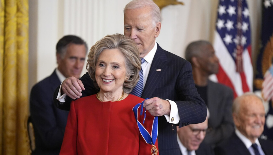 Hillary Clinton receives the Presidential Medal of Freedom at the White House, accompanied by her family.