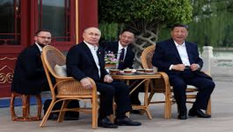 "Chinese President Xi Jinping and Russian President Vladimir Putin shake hands, symbolizing their pledge of a 'new era' partnership, seen as a challenge to U.S. hegemony." Photo: Reuters