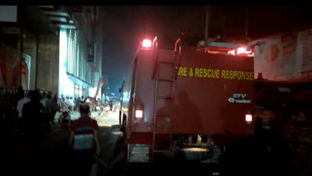 Firefighters extinguish flames at Rajshahi New Market’s Shasthitala area, where 12 shops were destroyed in a suspected electrical fire.