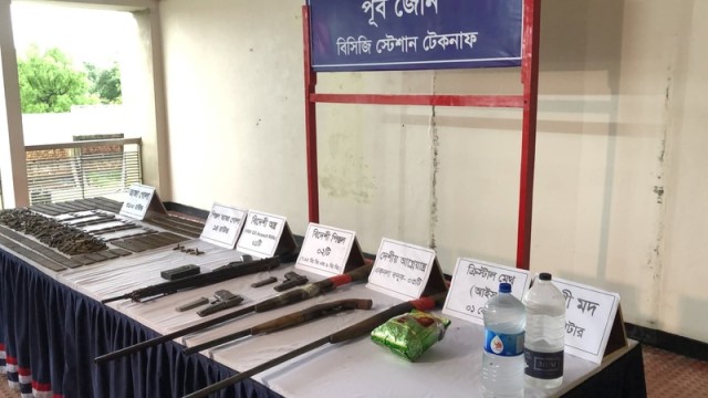 Recovered firearms, ammunition, and narcotics displayed after the joint operation in Teknaf hilly region.