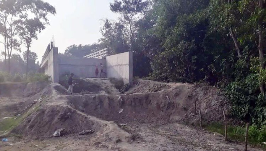 A newly constructed bridge over the Kalidas Pahalia river in Feni, costing approximately Tk 9 crore, stands unused due to the lack of a connecting road. Local residents urge authorities to build the necessary road to make the bridge functional. Photo: Voice7 News