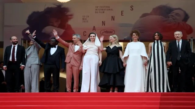 Celebrities pose for photographers on the red carpet at the opening night of the 2025 Cannes Film Festival, held at the iconic Palais des Festivals in Cannes, France.