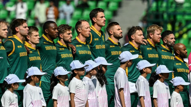 South Africa players stand for their national anthem before the start of Wednesday’s Champions Trophy semi-final against New Zealand at Gaddafi Stadium in Lahore Photo: AFP