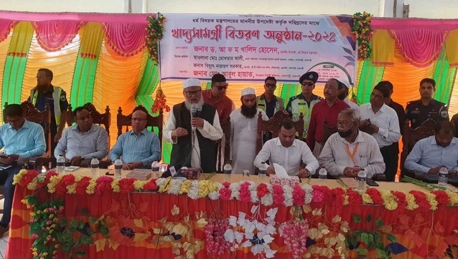 Religious Affairs Adviser Dr AFM Khalid Hossain speaks at a relief distribution event in Godagari Upazila, Rajshahi on Sunday, September 8, 2024.